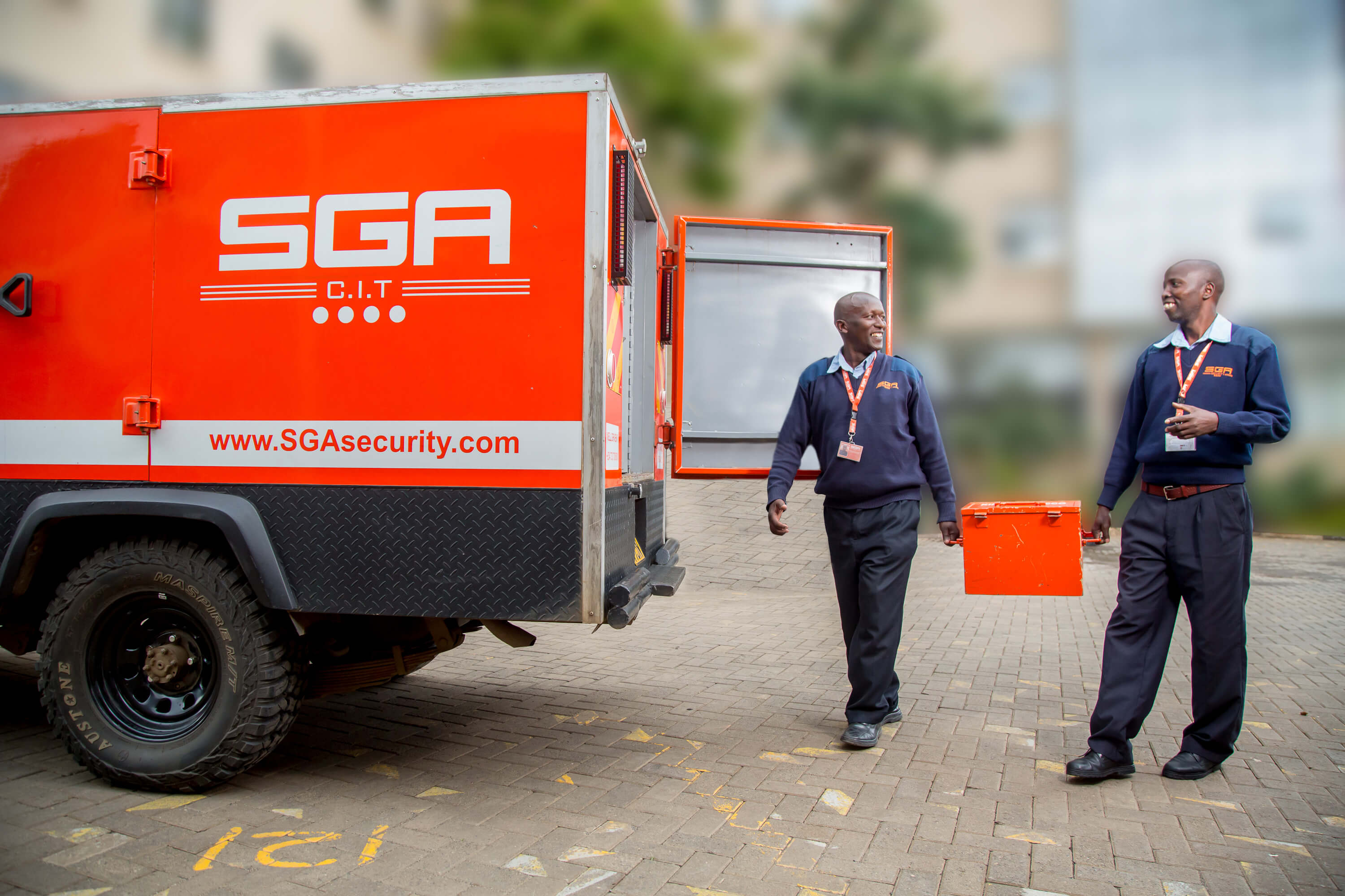 SGA personnel carrying cash in a box