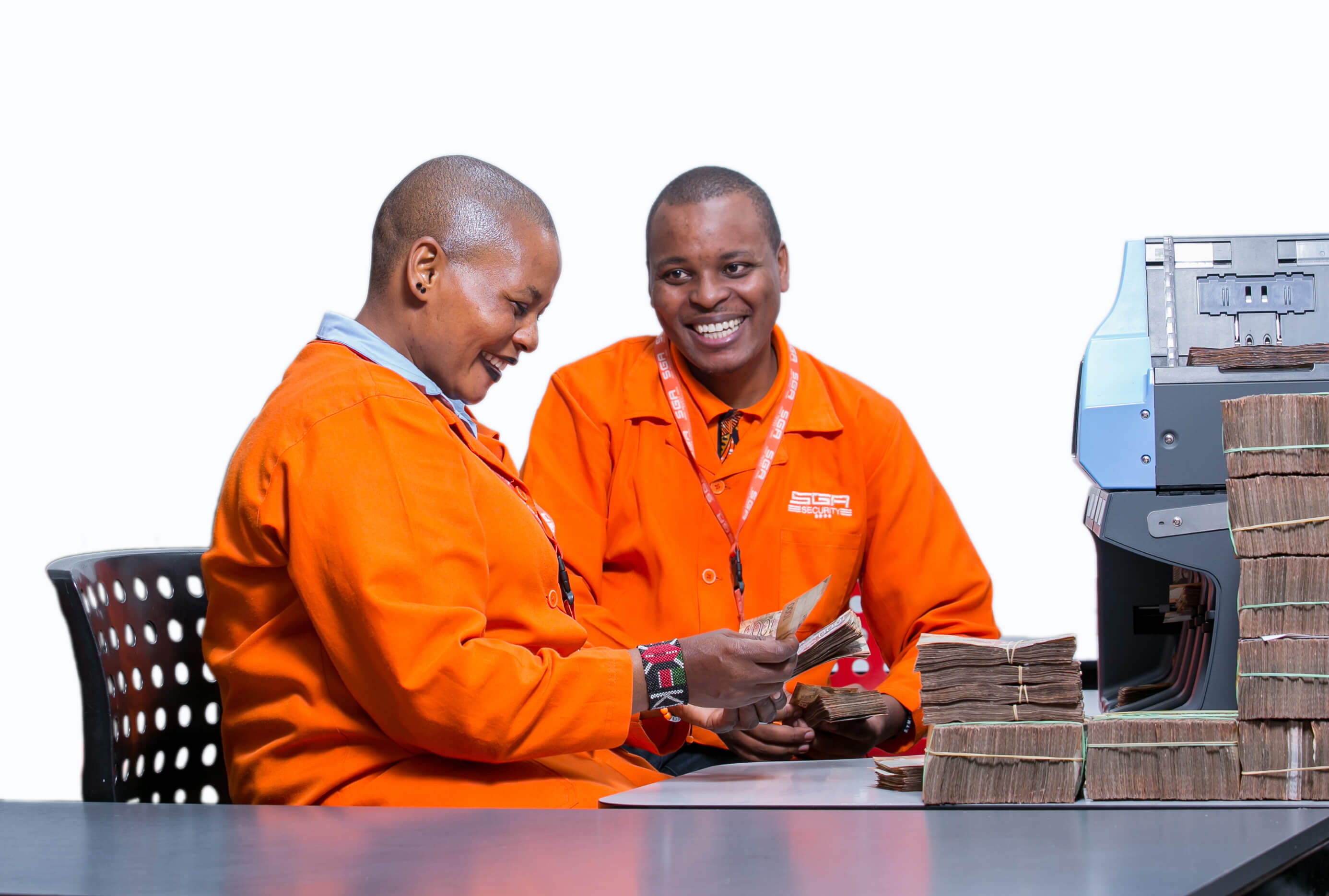 Two male SGA security personnel handling cash