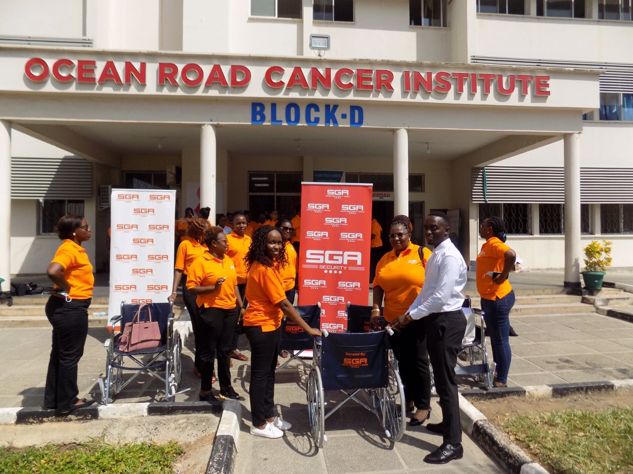 SGA staff members pose outside cancer institute