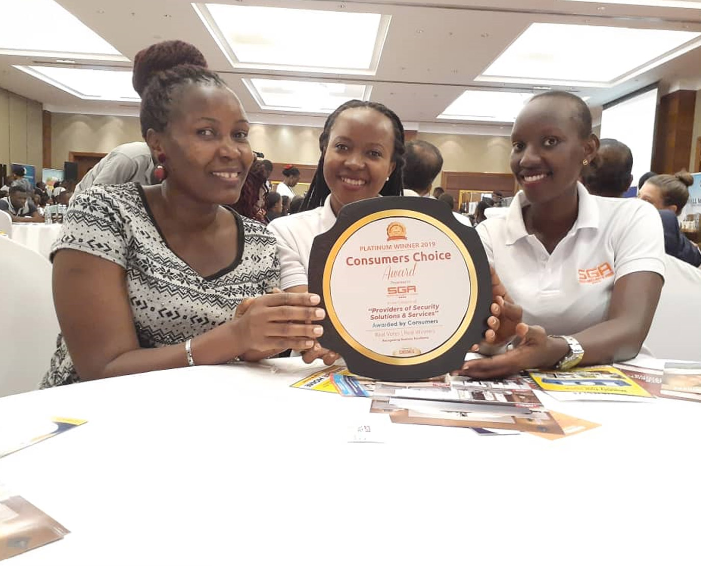 Women holding the consumers' choice award