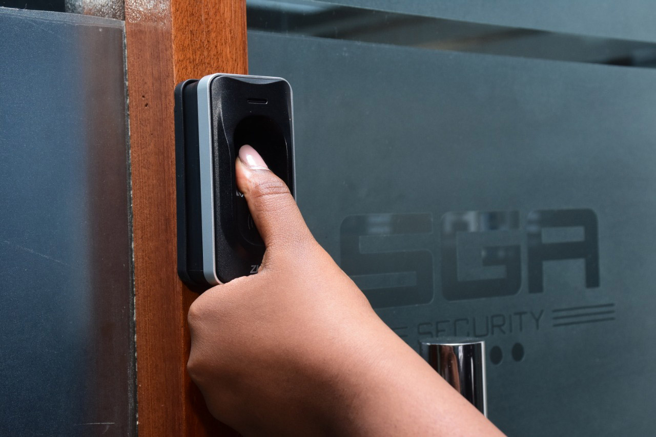 A finger being placed on a biometric system for printing